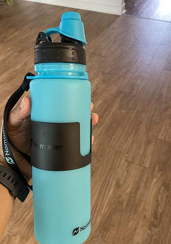 reviewer photo of the blue water bottle, filled up