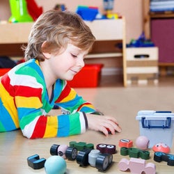 Image of child model playing with robot toys