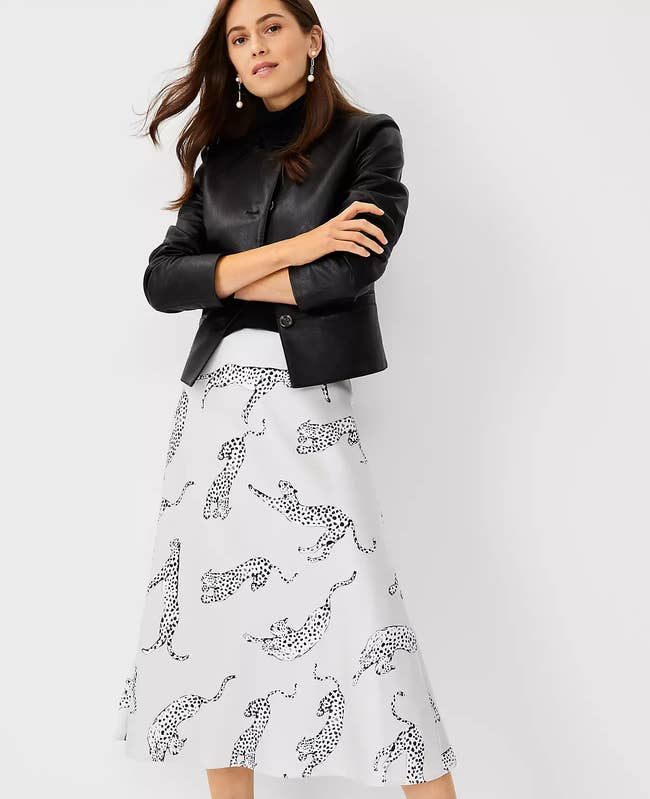 model in pale gray skirt with black and white leopards