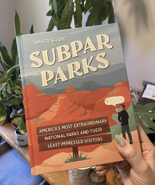 reviewer holding subpar parks book