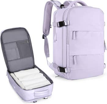 The backpack in lavender unzipped to show internal pockets and capacity