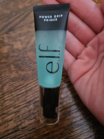 reviewer holding tube of grip primer