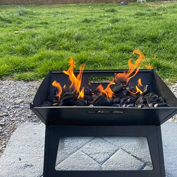 reviewer's small grill with charcoal in it and lit