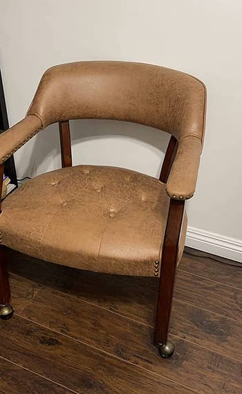 a reviewer photo of the chair in light brown 