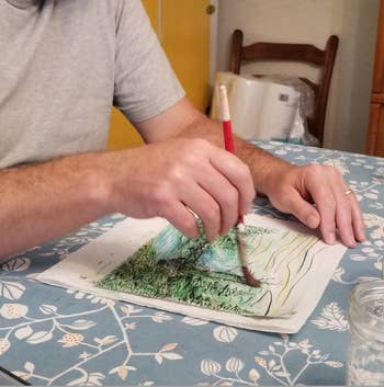 Person coating  with a brushwood  connected  insubstantial  astatine  a array  with leaf-patterned cloth