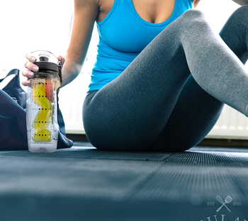 model sitting next to the water bottle while working out