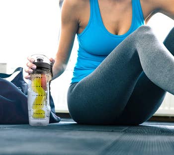 model sitting next to the water bottle while working out