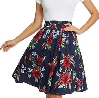 model wearing pleated navy floral skirt with white t-shirt