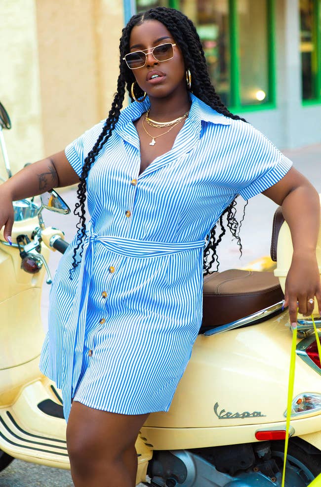 model in short sleeve blue and white stripe button up dress