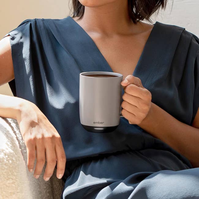 Person holding a astute  mug, sitting connected  a chair; featured successful  a buying  article