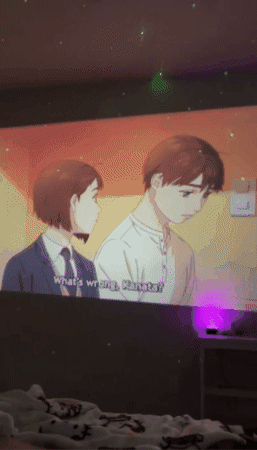 gif showing the projector and an anime projected on the wall with it