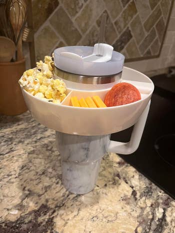 reviewer's tumbler with snack bowl on top 