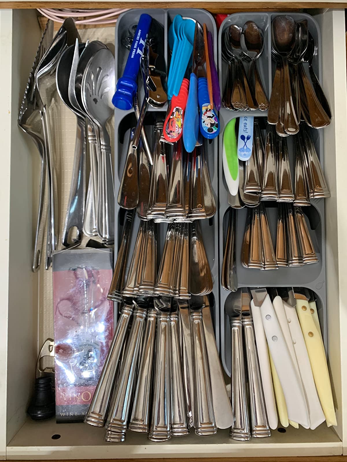 reviewer photo of two of the organizers inside of a drawer, neatly holding various utensils