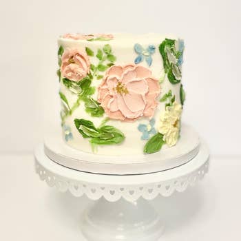 a beautiful cake with flowers frosted on it
