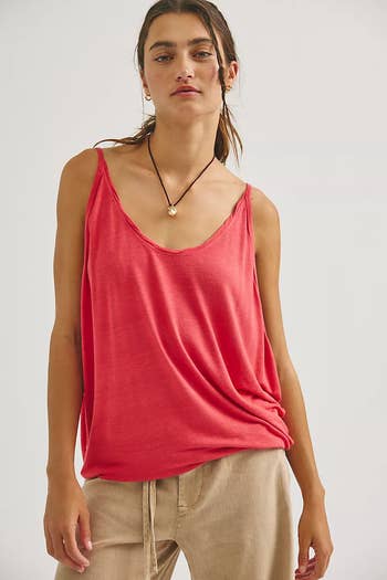 Person in casual sleeveless top and light pants, wearing a necklace; suitable for relaxed, stylish summer wear