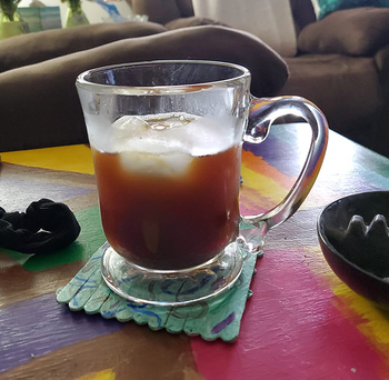 reviewer photo of a glass mug filled with an iced latte