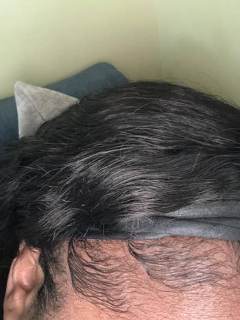 Close-up of styled hair with a wide black headband, focusing on smooth edges