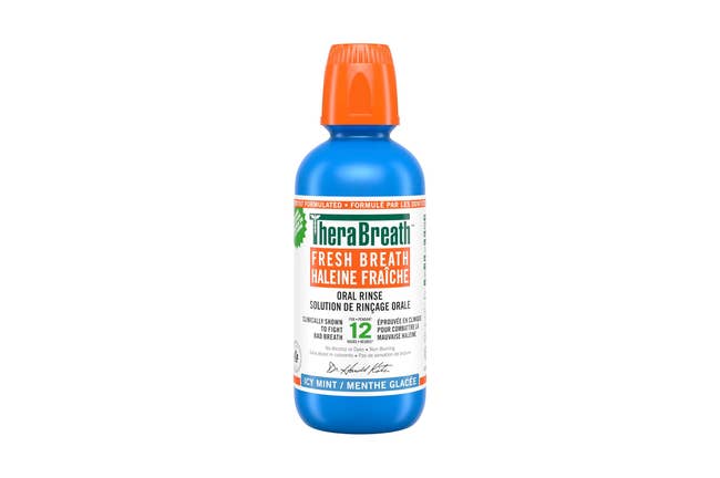 TheraBreath Fresh Breath oral rinse bottle with orange cap, offers 12-hour protection, in icy mint flavor