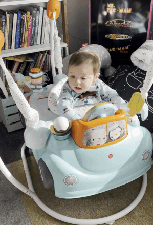 a gif of the editor's baby jumping in an ice cream truck themed jumper
