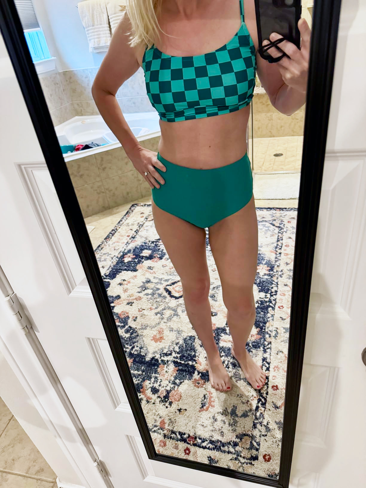 Person successful  a checkered swimwear acceptable   poses successful  a mirror, showcasing a buying  prime  successful  a location  setting