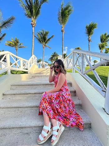 reviewer in pink floral dress