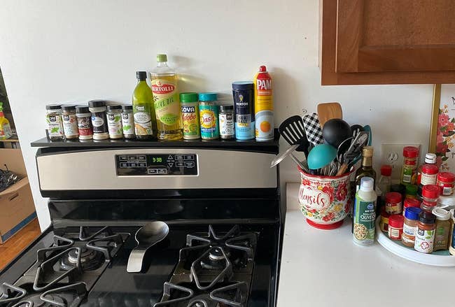 various spices and supplies on a black stove shelf