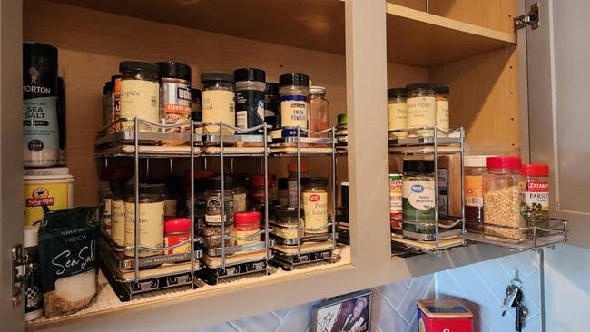 Organized room furniture with sliding racks holding assorted spice jars and seasonings neatly arranged for casual access