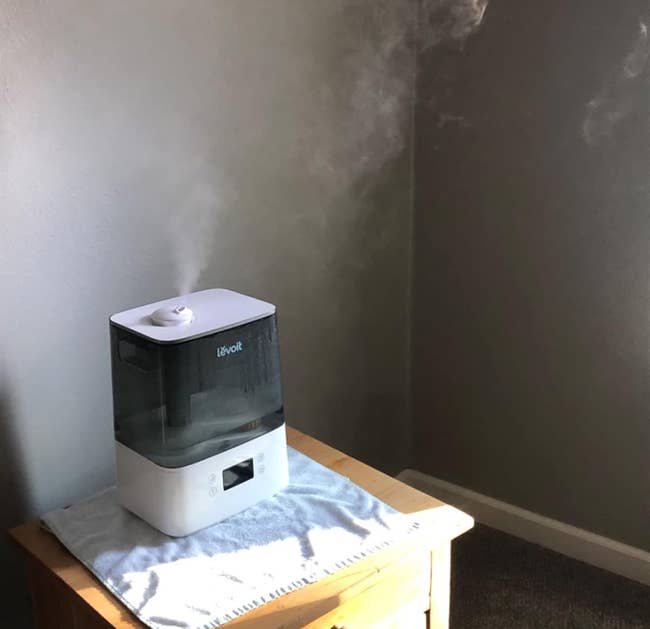 reviewer photo of the humidifier on a night stand
