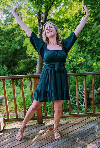 reviewer in the green mini dress