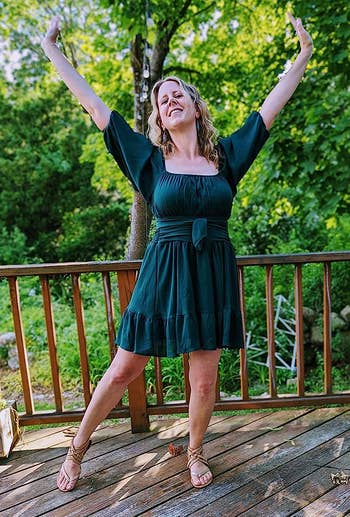 reviewer in the green mini dress