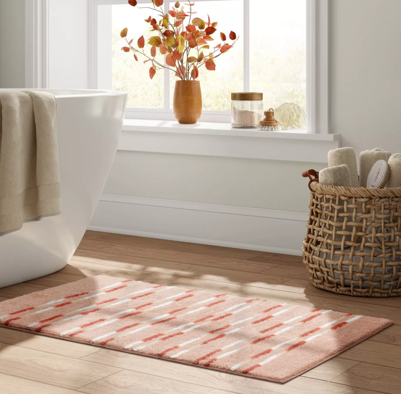 a pink tufted rug in a bathroom