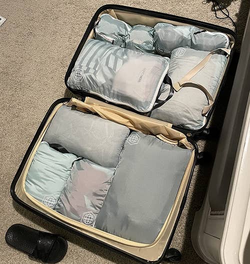 a suitcase packed with compression cubes