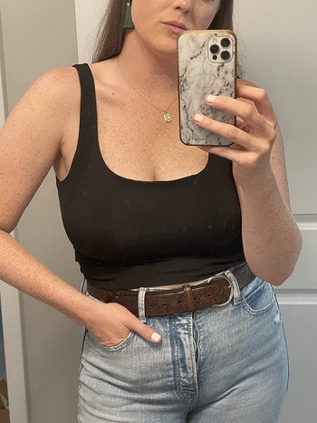 a reviewer in a stretchy square neck black tank