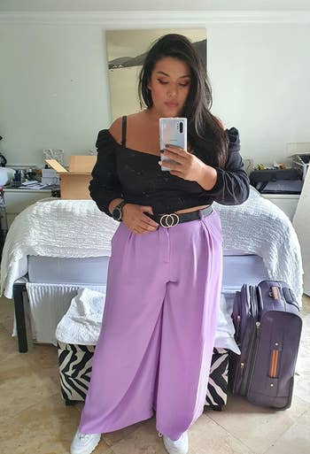 a reviewer wearing the pants in purple