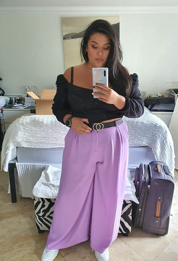 a reviewer wearing the pants in purple
