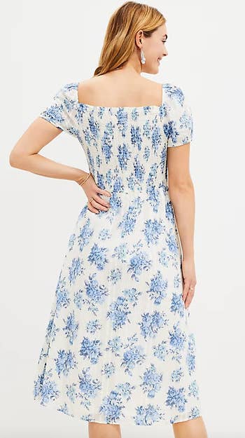 Model wearing the Loft blue and white midi dress, back