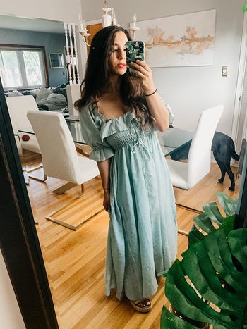 reviewer wearing green maxi dress