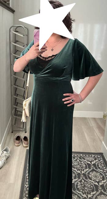a reviewer in the dark green velvet dress