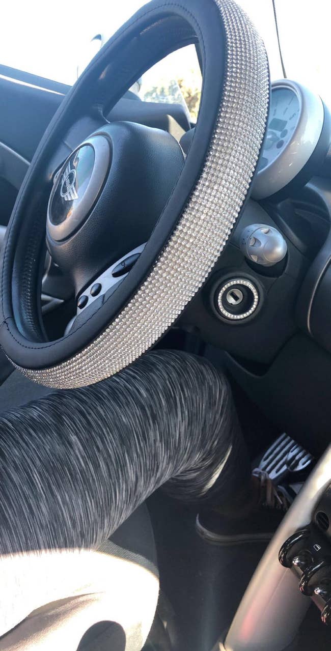 Reviewer photo of the steering wheel cover with rhinestones throughout