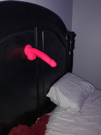 Dildo attached to headboard