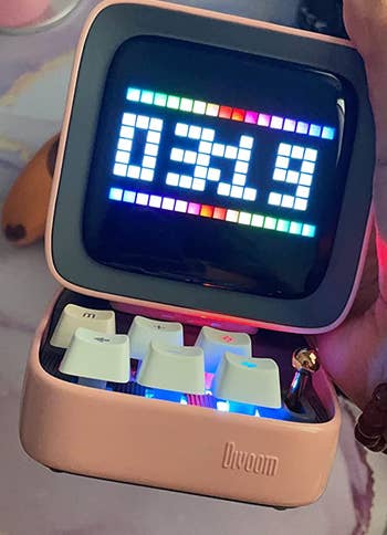 a reviewer's pink version displaying the time 