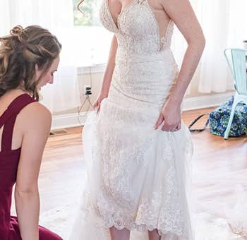 reviewer wearing the sandals with a wedding dress