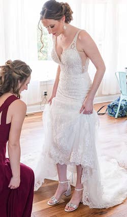 reviewer wearing the sandals with a wedding dress