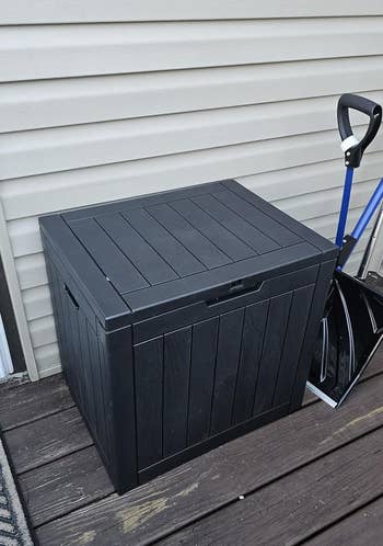 a square outdoor storage box on a deck 