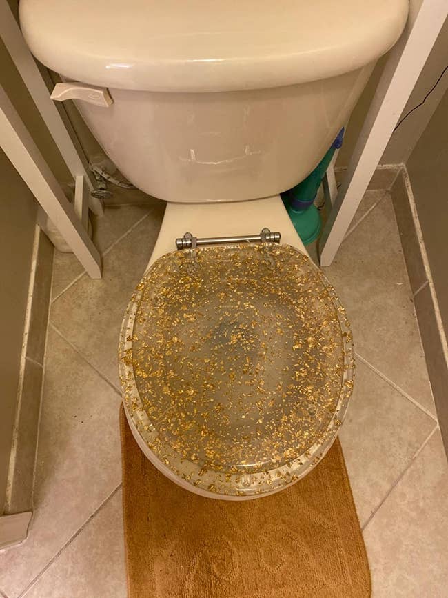 reviewer image of the resin toilet seat cover on a toilet