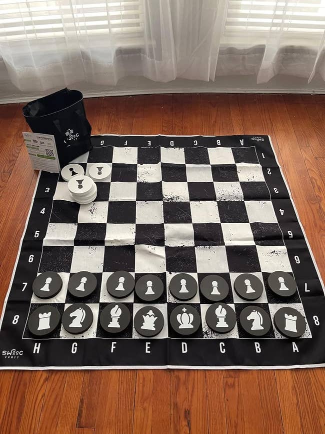 reviewer image of the mat set up with the foam chess pieces