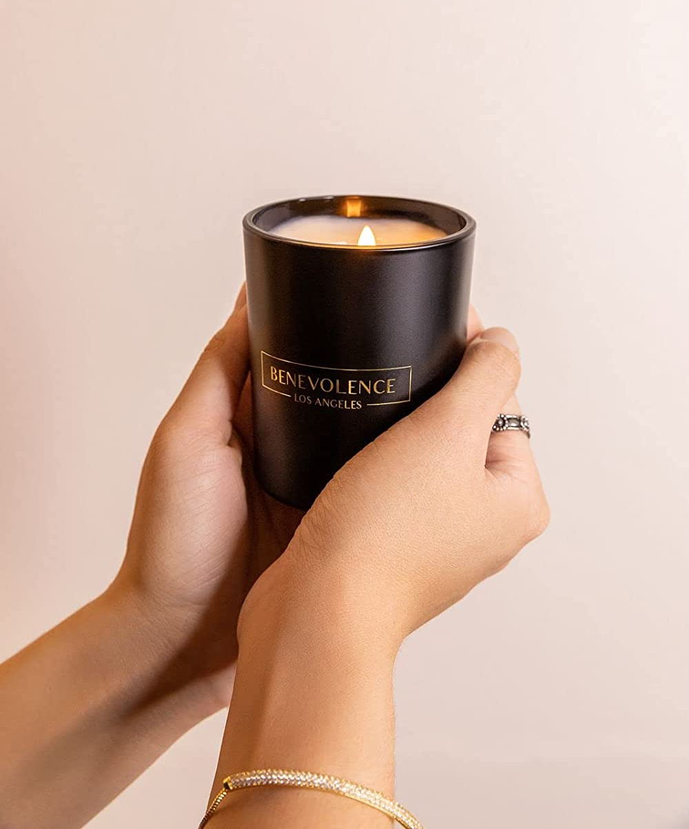 hands holding the black candle