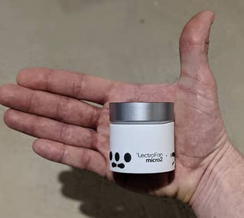 Reviewer holding the white noise machine to show how small it is