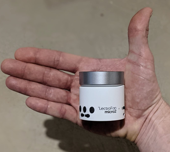 Reviewer holding the white noise machine to show how small it is