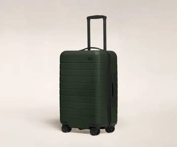 a dark green away suitcase